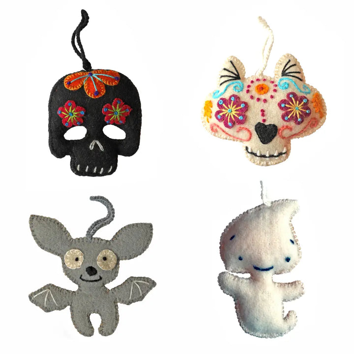 Four decorative Halloween ornaments on a white background