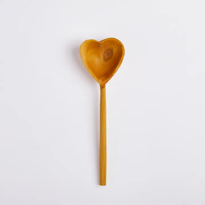 Heart-shaped wooden tea spoon on a white background