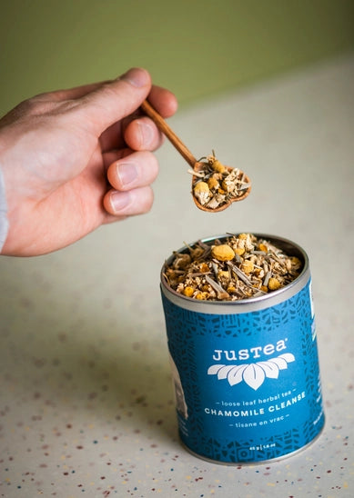 Heart spoon over a 'Justea' chamomile cleanse tea canister.
