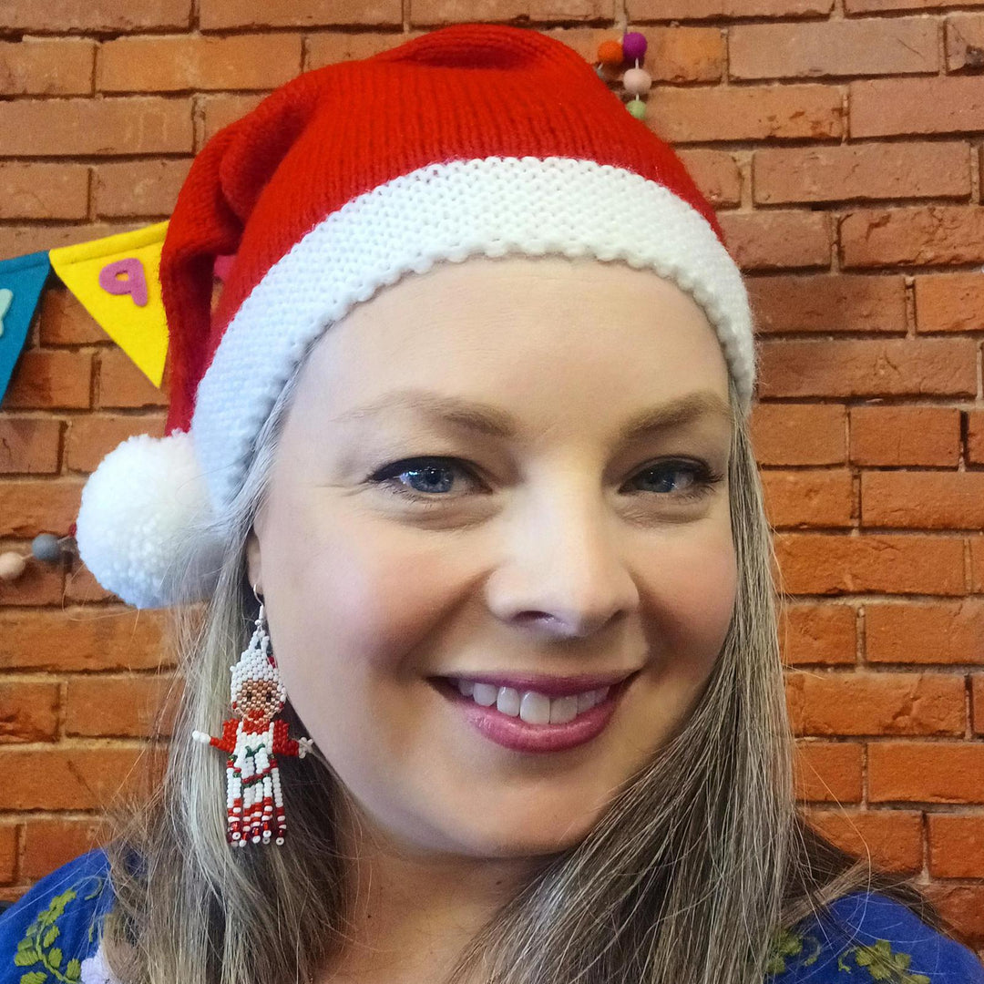 Woman wearing hand knitted santa hat
