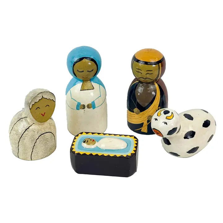 A set of hand-painted wooden nativity figurines including Mary, Joseph, baby Jesus in a manger, and a cow, shown on a plain white background.