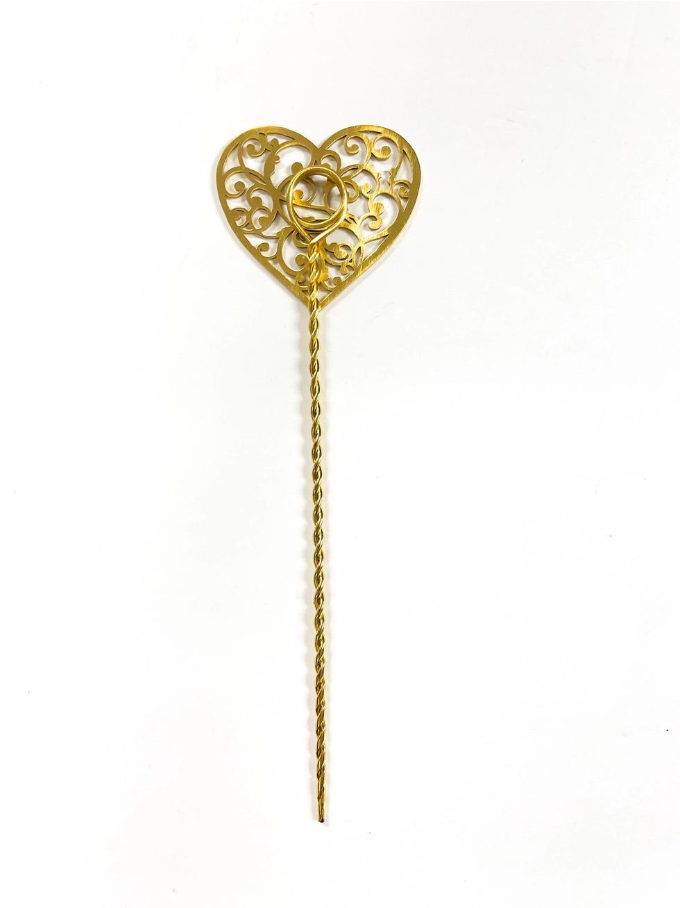 Gold heart-shaped plant stake on a white background