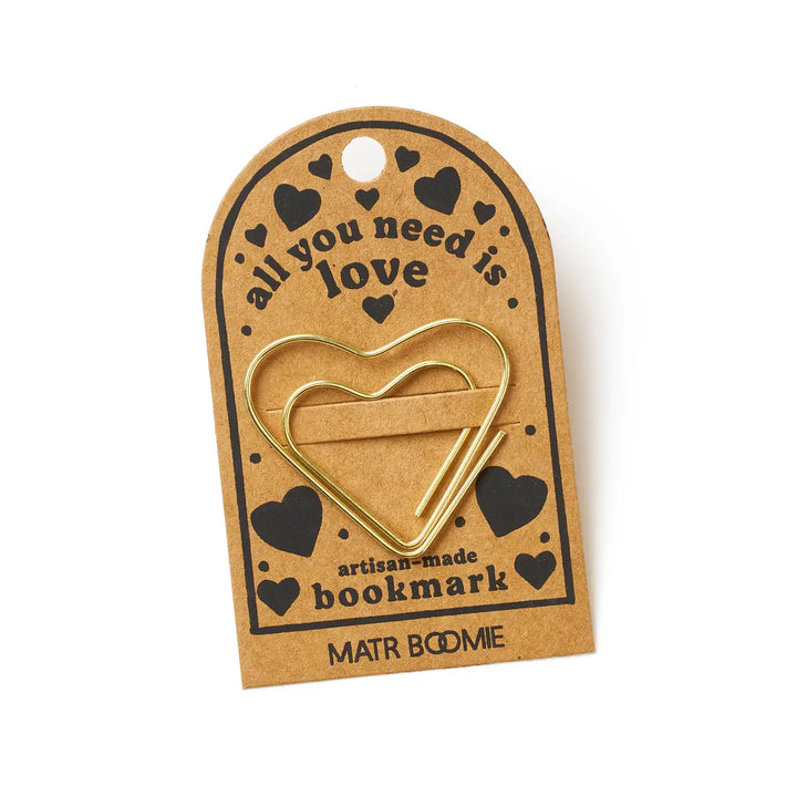 Heart-shaped gold bookmark on a brown card with 'all you need is love' text, on a white background.