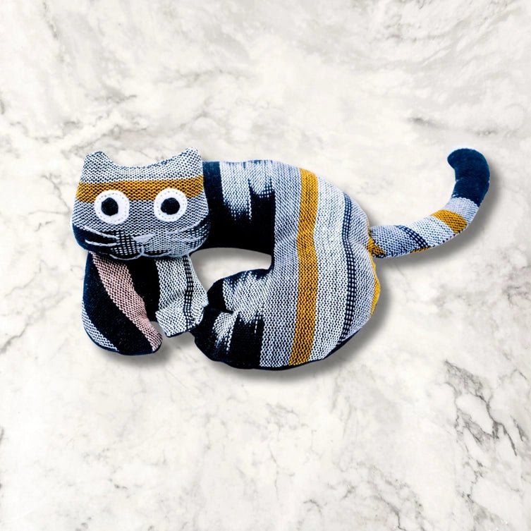 Striped cat trivet on a white marble surface