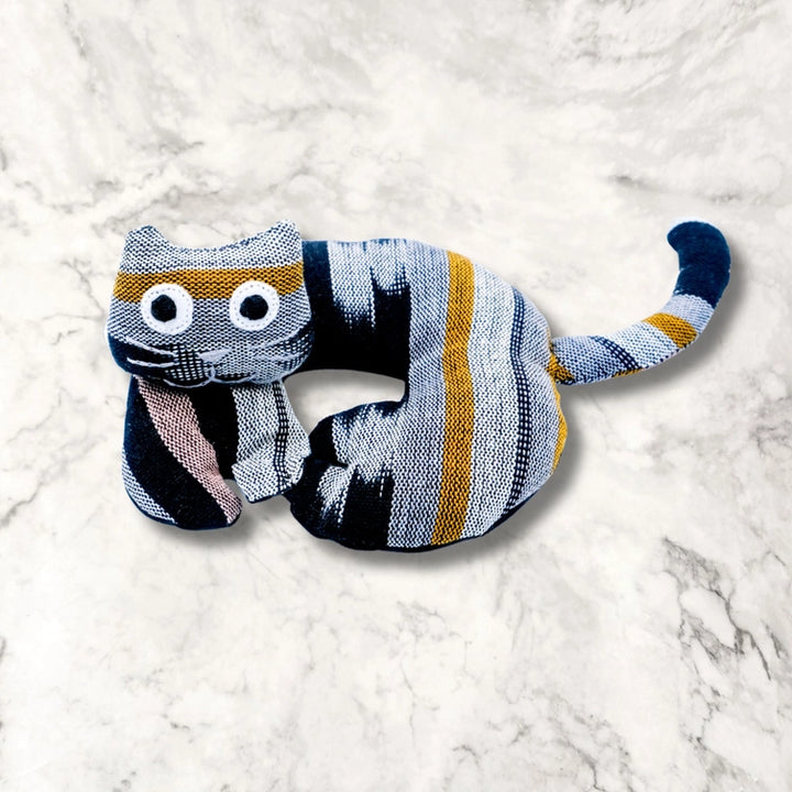 Striped cat trivet on a white marble surface