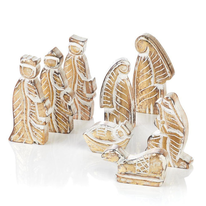 A hand-carved wooden nativity set with whitewashed figures 