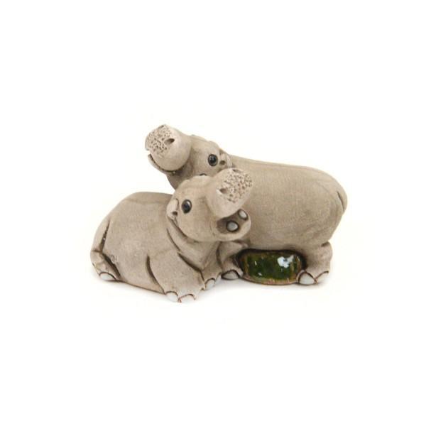 Two ceramic hippos on a white background