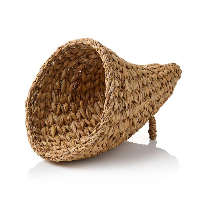 A beige, woven cornucopia made from natural fibers, with a circular shape and an opening at the top, set against a white background.