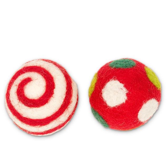 Two felted toys, one with red and white spiral pattern and the other with red base and white spots.