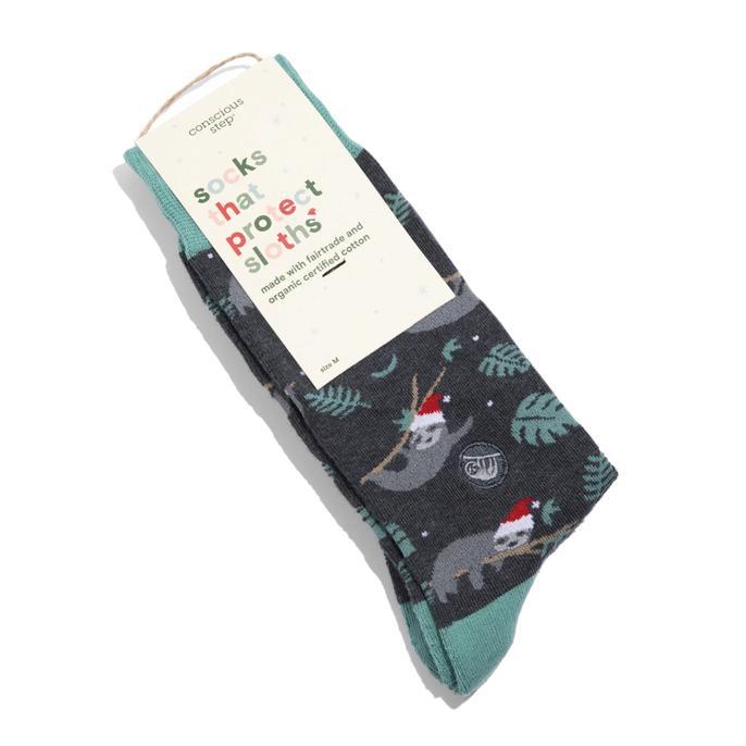 A pair of holiday socks with a sloth design, featuring green color and patterns related to sloths, Santa Claus, and Christmas.
