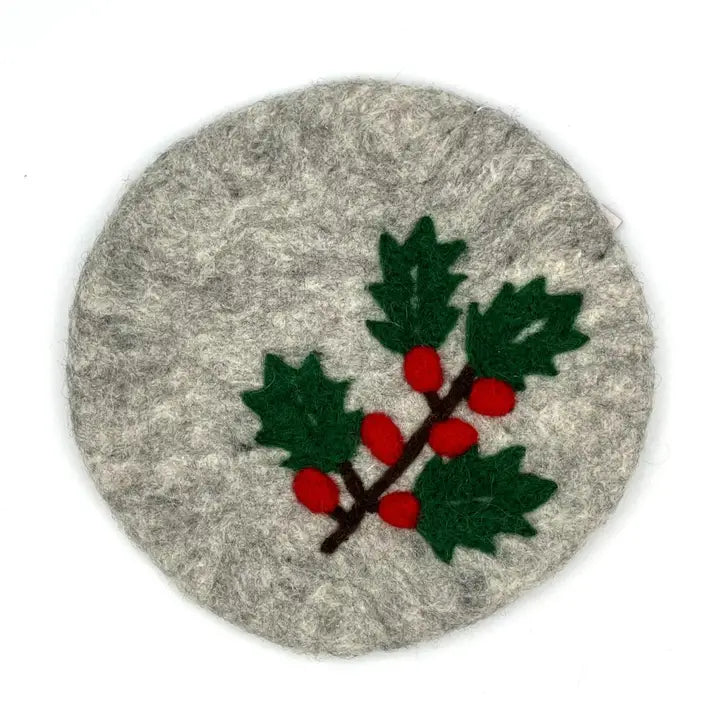 A round gray felt trivet featuring an felted holly branch with green leaves and red berries, shown on a plain white background.