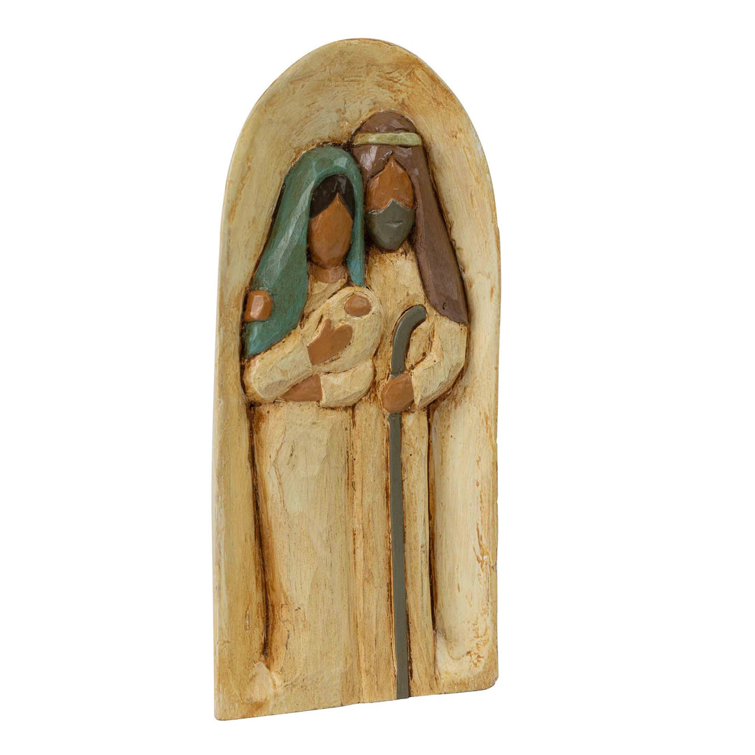 Carved wood holy family on white background