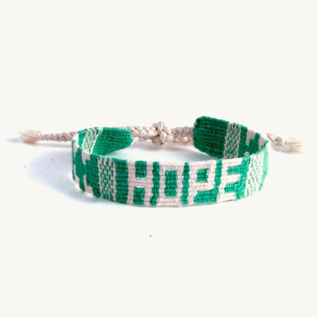 Green and white braided bracelet with word "Hope" on a white background