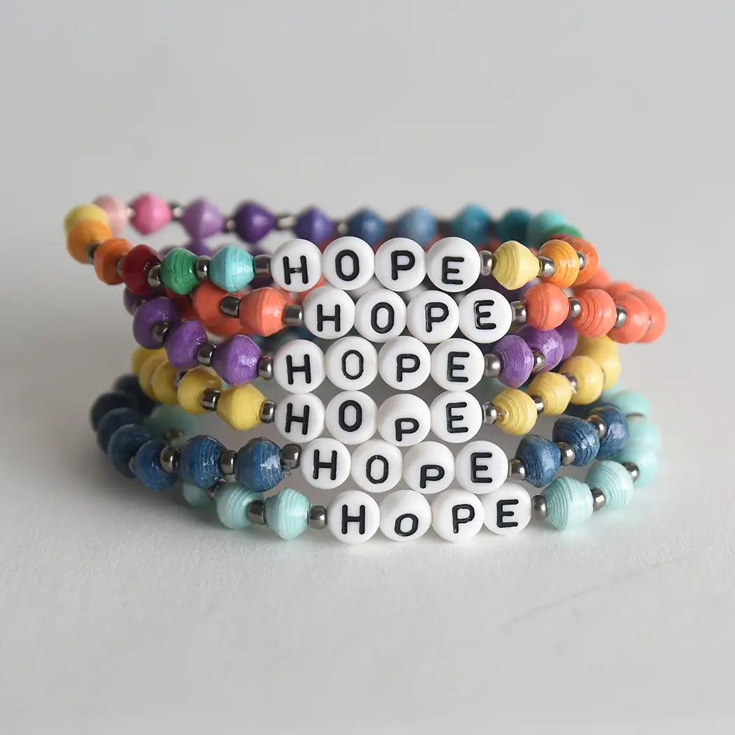 Colorful 'HOPE' beaded bracelets on a light gray background