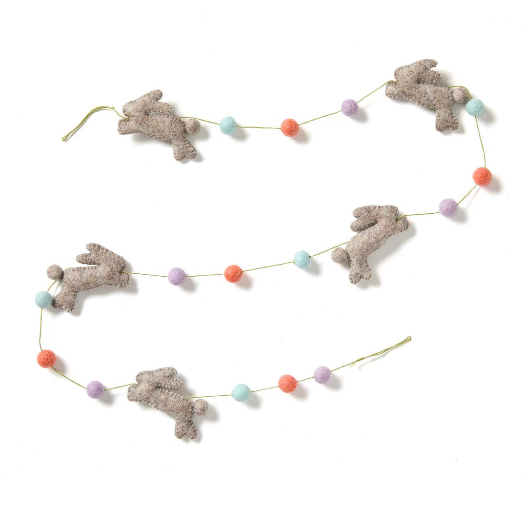 Decorative garland with felt bunny figures and colorful felted beads on a white background