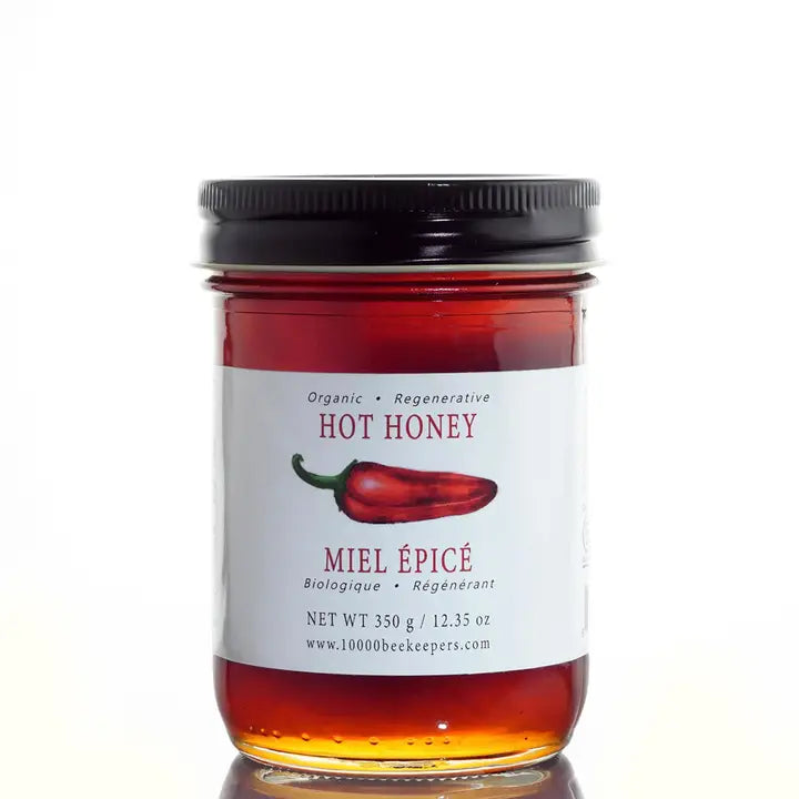 large jar of hot honey on a white background