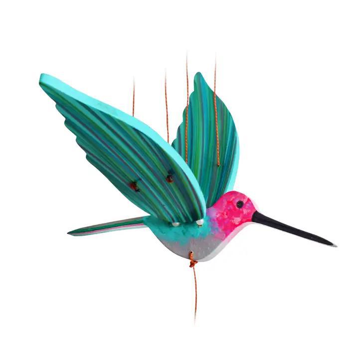 A hummingbird flying mobile on a white background
