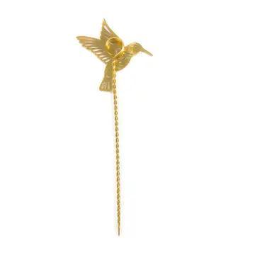 Gold bird-shaped plant stake on a white background
