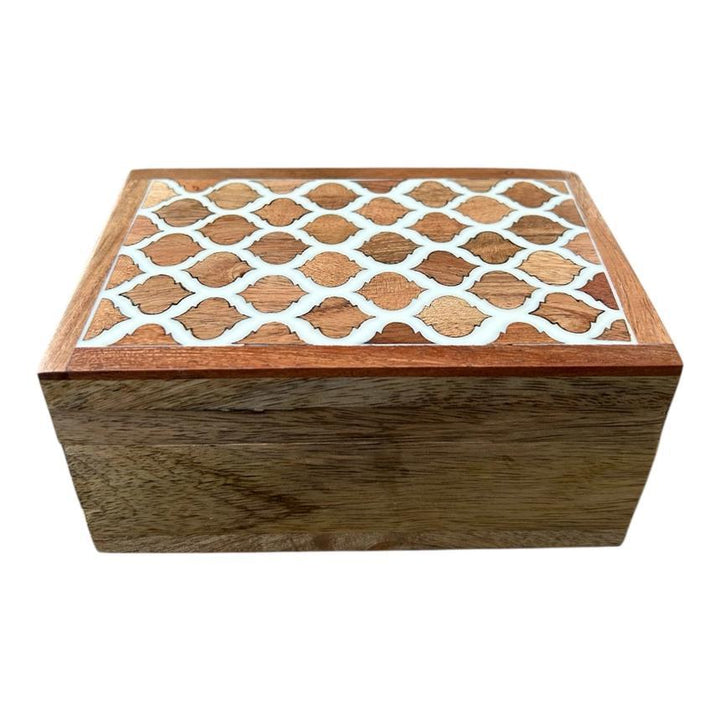 Wooden box with a decorative lattice pattern on the lid against a white background