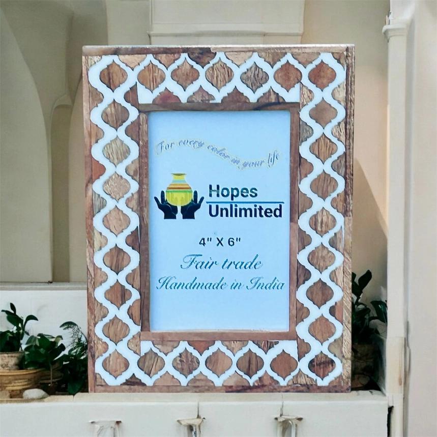 Wooden photo frame with decorative patterns on a white surface, featuring 'Hopes Unlimited' branding.