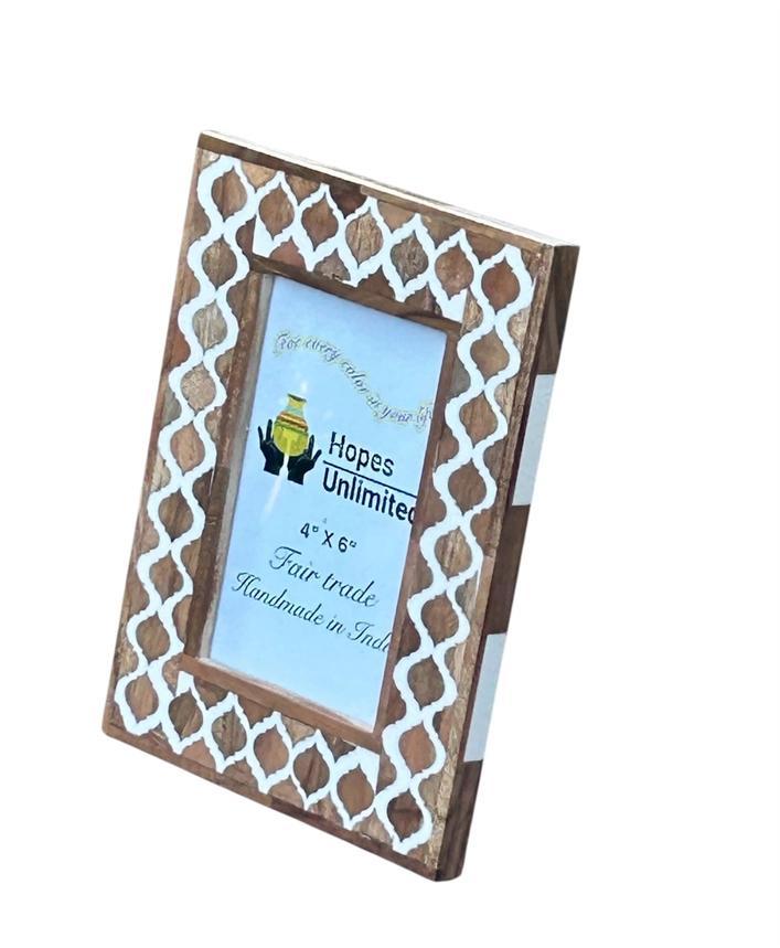 Wooden photo frame with white lattice design on a white background
