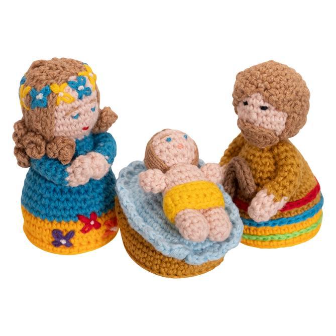 Hand crocheted nativity figurines on a white background. 