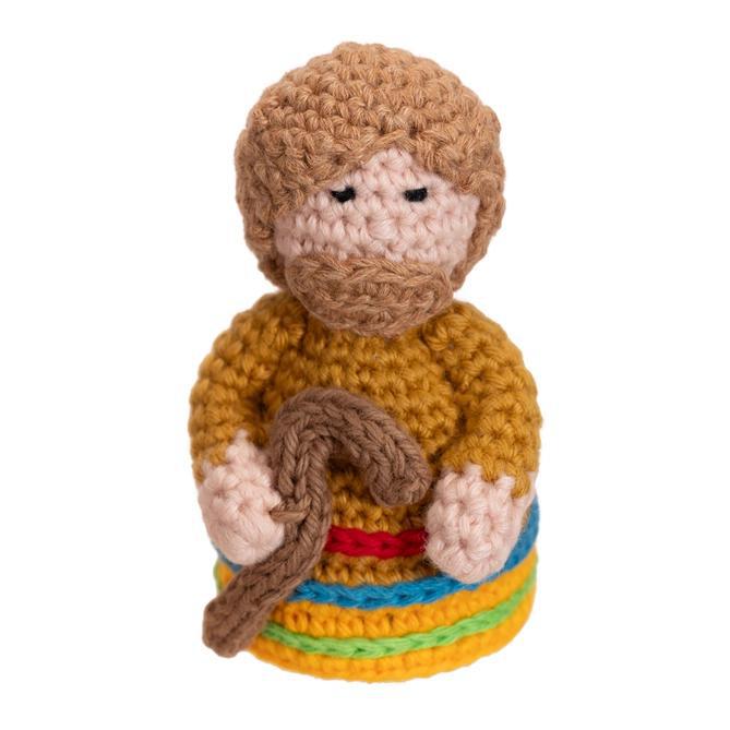 Close up of hand crocheted Joseph with his staff from the nativity scene. 