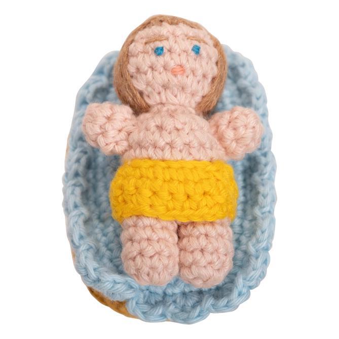 Close up of hand crocheted baby Jesus from the Nativity scene.