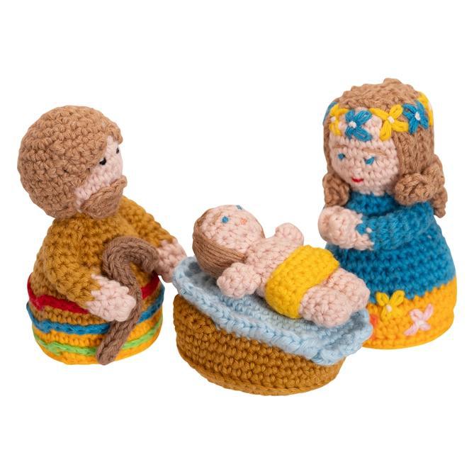 Hand crocheted nativity scene with bright colors against a white background. 