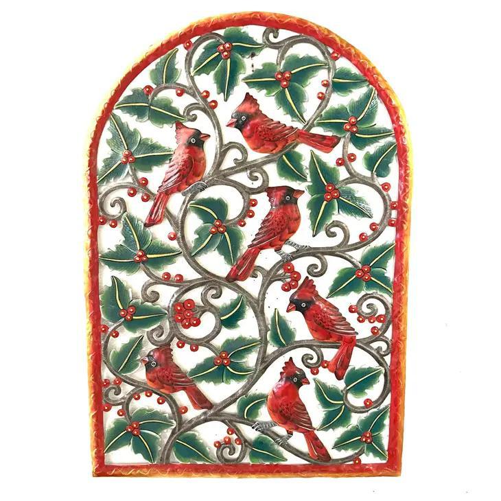 Handmade metal art of cardinals on tree branches of holly, with green leaves and red berries. 