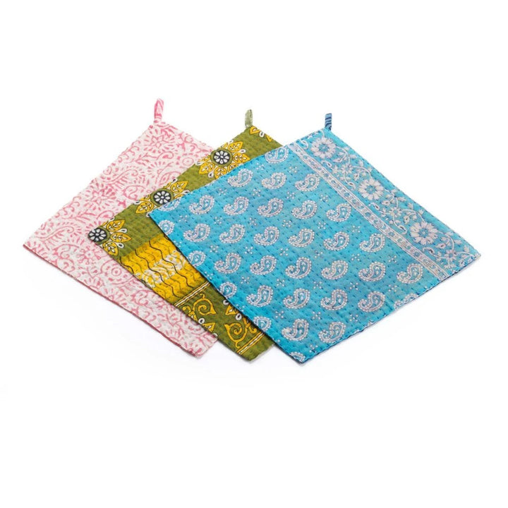 Set of four colorful patterned dishcloths on a white background