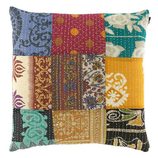 Multicolored patchwork pillow with various patterns on a white background