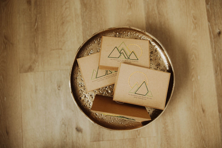 Cards on a metallic tray on a wooden surface