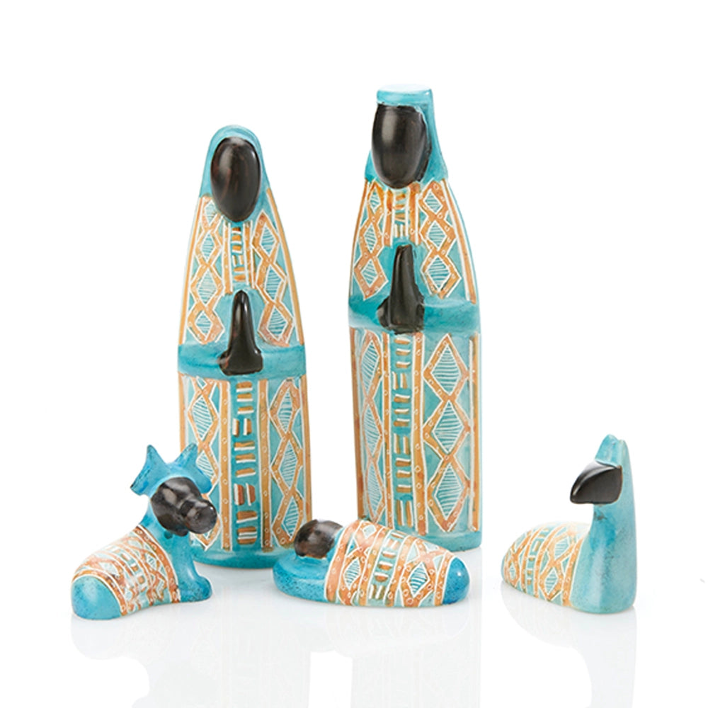 A set of four soapstone nativity figurines in turquoise, orange, and black, including a Mary, Joseph, two sheep and baby Jesus.