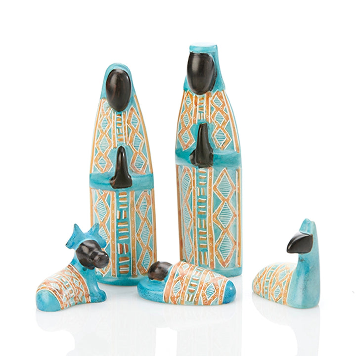 A set of four soapstone nativity figurines in turquoise, orange, and black, including a Mary, Joseph, two sheep and baby Jesus.