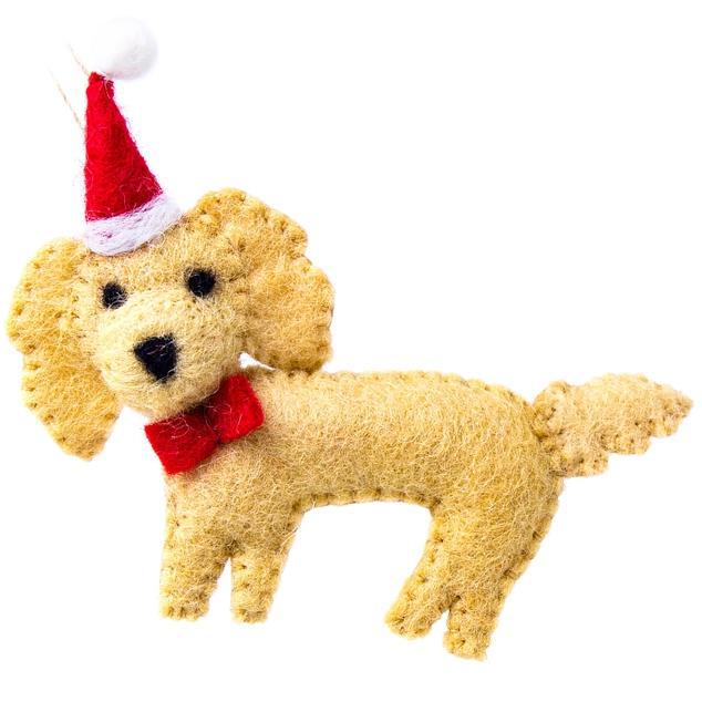 Stuffed dog toy with a Santa hat and red bow tie on a white background