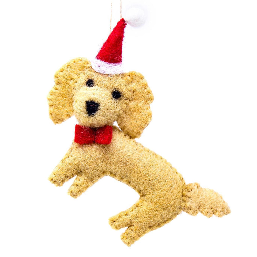 Dog-shaped Christmas ornament with a red bow tie and Santa hat on a white background