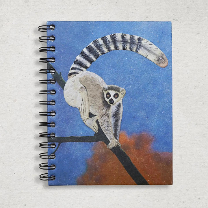 Mr. Ellie Pooh Notebook with a lemur design on the cover against a blue and orange background
