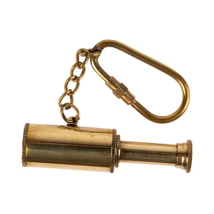 Brass telescope keychain on a white background