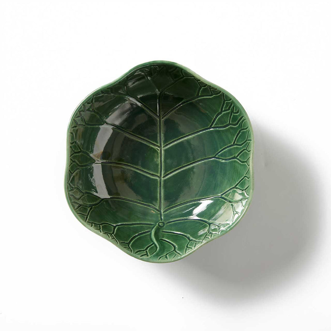 Green leaf-shaped ceramic dish on a white background