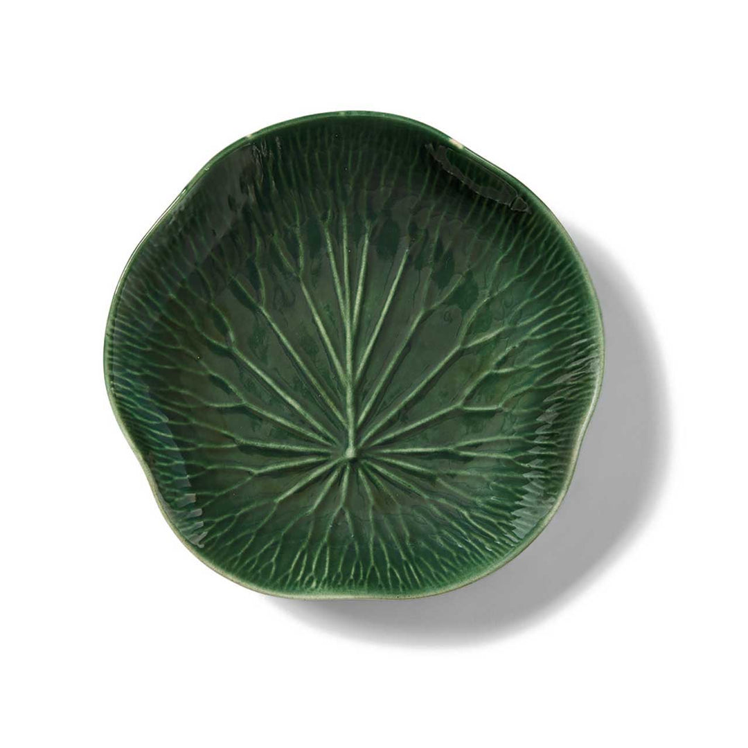 Green ceramic plate with leaf pattern on a white background