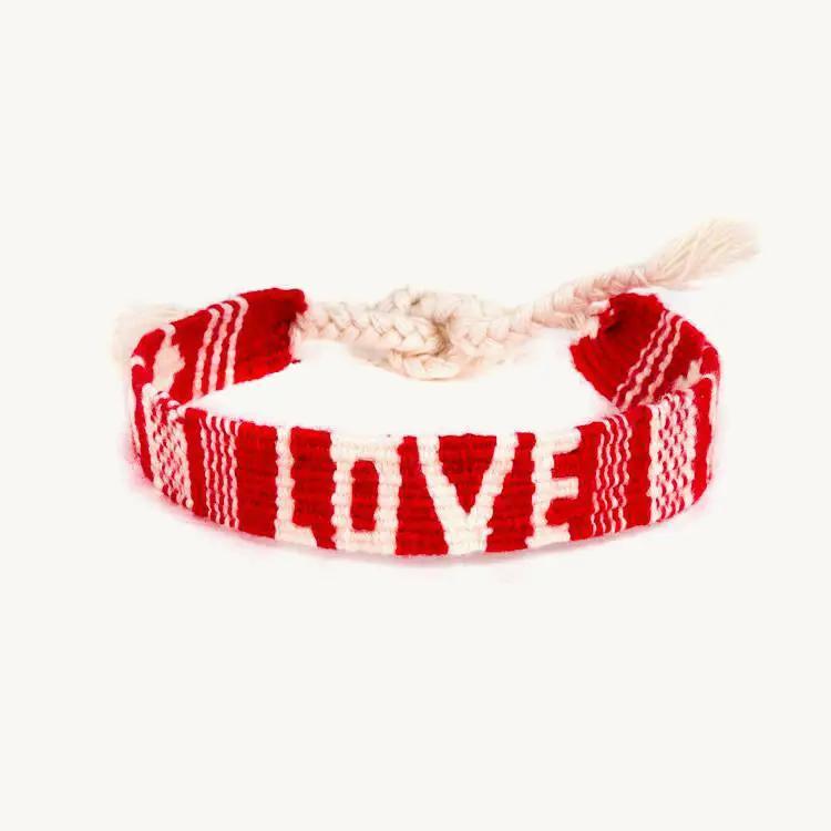 Red and white braided bracelet with 'LOVE' text on a white background