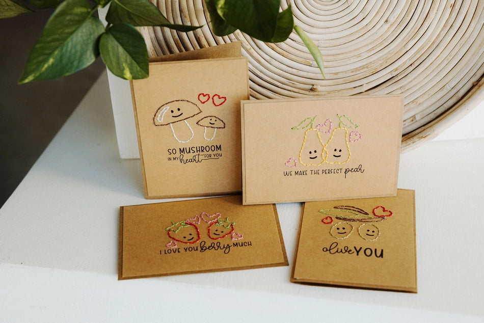 Set of four brown greeting cards with food illustrations on a white surface.