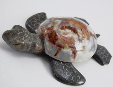 Decorative turtle sculpture with a shell featuring marbled patterns on a white background