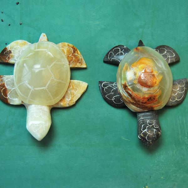 Two turtle-shaped objects on a green background