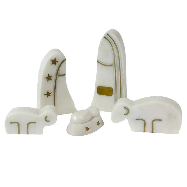 White nativity scene figurines with gold details on a white background