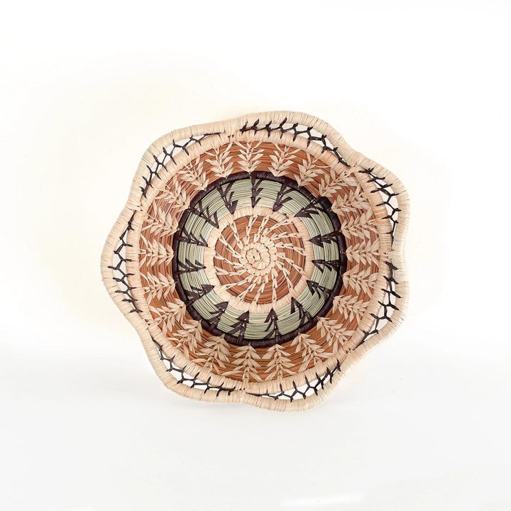Decorative woven basket with a multicolor circular design on a white background