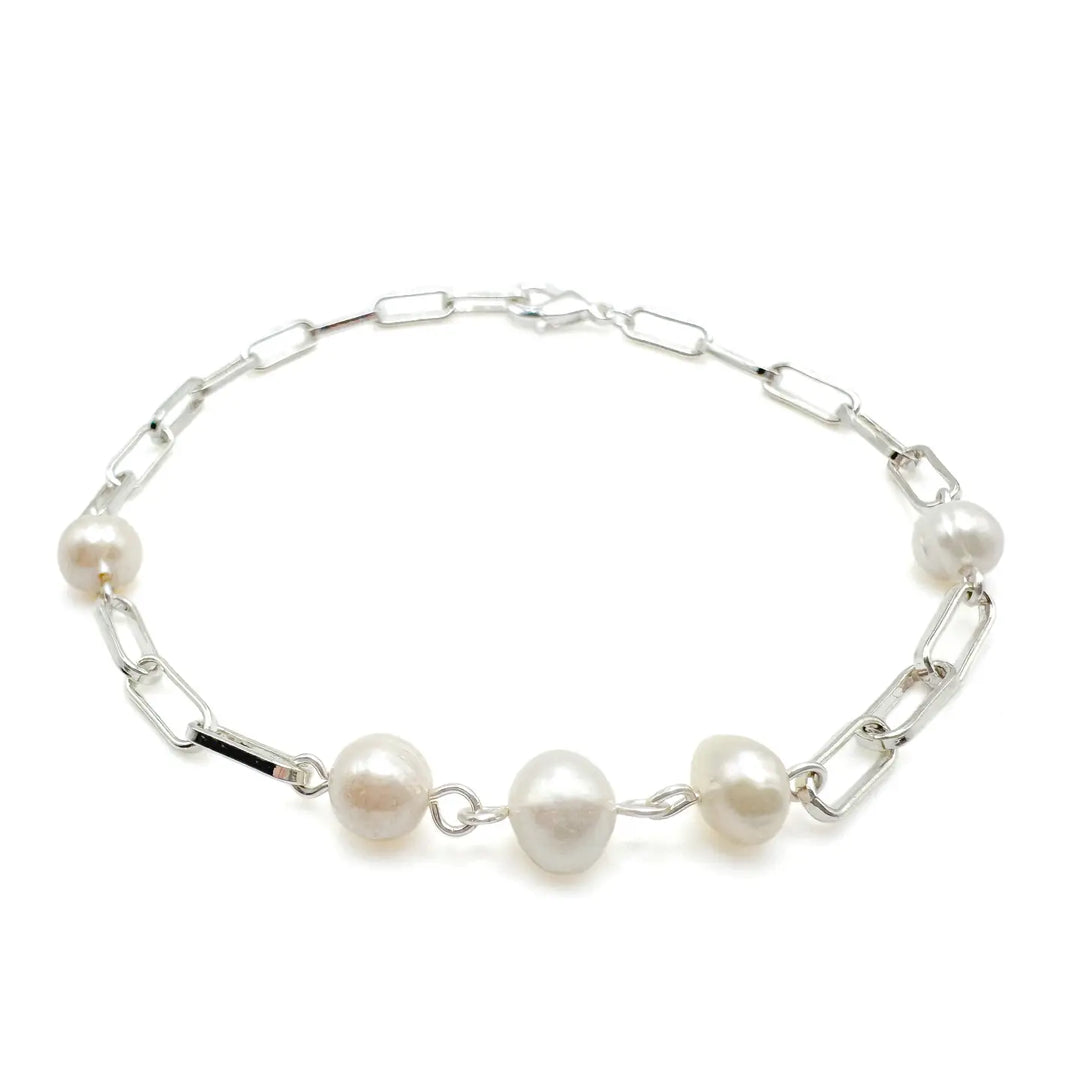Silver bracelet with pearls on a white background