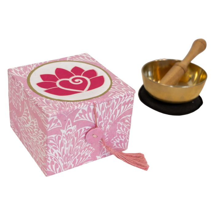 a meditation bowl with a pink gift box