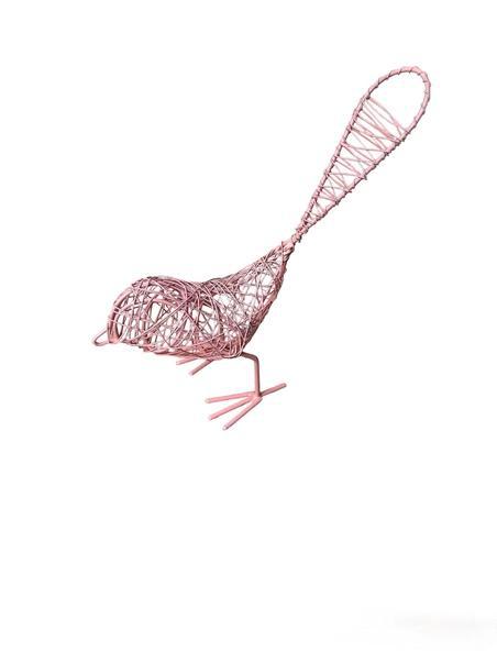 A pink hand made metal wire bird on a white background.